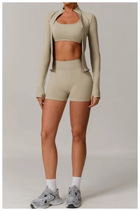 Three-piece yoga set with zip jacket, sports bra, and high-waist shorts in khaki fabric