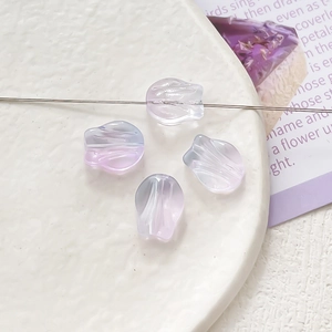 Close-up of purple gradient tulip-shaped glass beads for DIY jewelry making