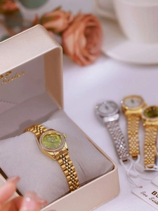 Luxe gold women watch with green dial and diamond bezel in elegant gold gift box
