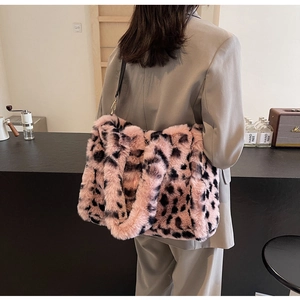 Pink leopard print plush tote bag worn by a model in a minimal modern interior