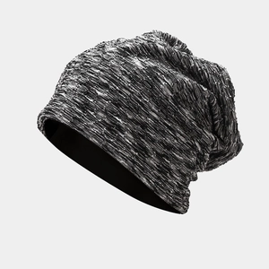Close-up of the knitted tie-dye pattern and textured fabric of the slouchy beanie hat