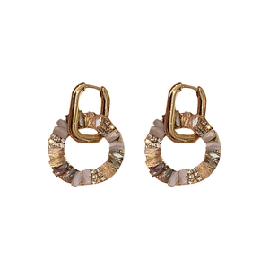 Vintage gold hoop earrings with sparkling zircon round charms on a clean white background