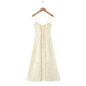 Elegant beige floral halter maxi dress with corseted back detail on a wooden hanger