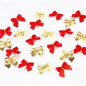 Close-up of red satin and golden metallic Christmas bows for holiday gift decoration