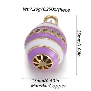 Macro view of purple and white enamel egg charm with crystals and gold hollow base