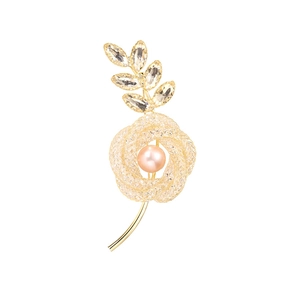 Elegant gold flower brooch with freshwater pearl and crystal leaves on white background