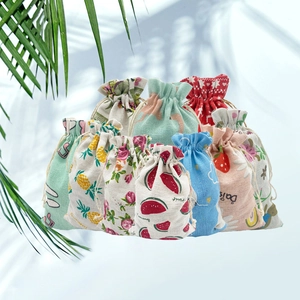 Detail of drawstring fabric gift bags featuring watermelon, strawberry and floral prints
