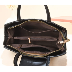 Black crocodile embossed Boston handbag showing spacious interior compartments and zippers