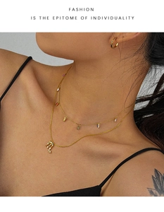 Close-up of Scorpio zodiac necklace with colorful zircon stones on gold layered chains