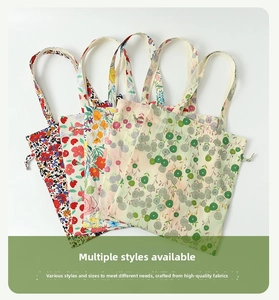 Detail of four floral print canvas tote bags with various patterns on white background