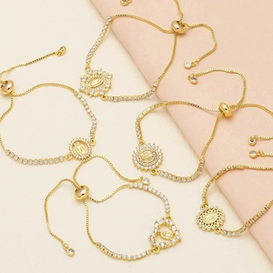 Gold-plated religious bracelet with Virgin Mary pendants and sparkling zircon crystals