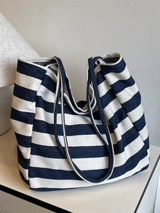 Minimalist blue and white striped canvas tote bag shown on a minimalist white surface