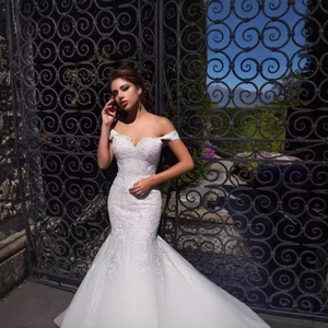 Elegant white off-shoulder mermaid wedding dress with intricate floral lace embroidery