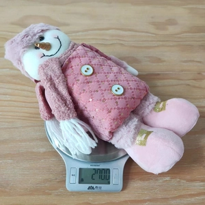 Pink sequin plush snowman doll on kitchen scale showing 270g weight detail
