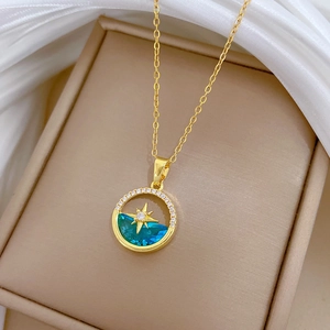 Elegant gold celestial necklace with blue gemstone star pendant and zircon accents
