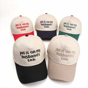 Fashionable baseball caps with letter embroidery in various contrast colors on white background