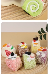 Macro detail of artificial PU Swiss rolls with realistic cream and fruit toppings