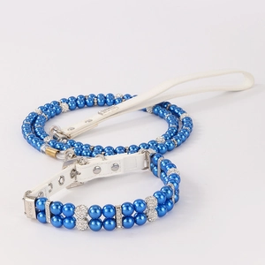 Close-up of pet collar with double-row blue pearls, rhinestones and white leather