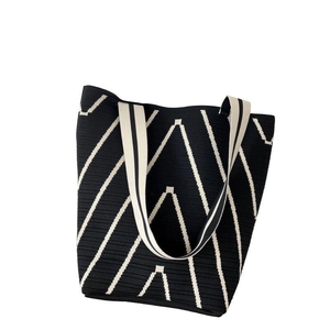 Detail showing the intricate wave pattern texture on this large knitted tote bag