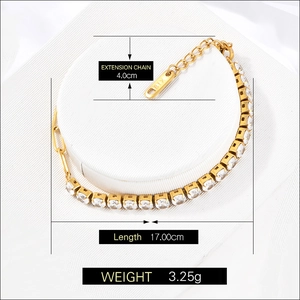 Gold-plated stainless steel square zircon tennis bracelet with extension chain shown on silk