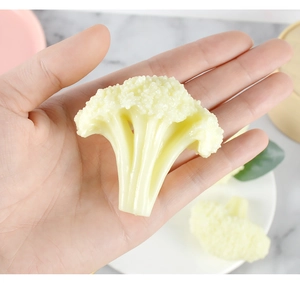 Detailed close-up of a realistic PVC cauliflower model held in hand for scale