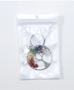 Detailed macro view of Tree of Life keychain with colorful natural crystal stones