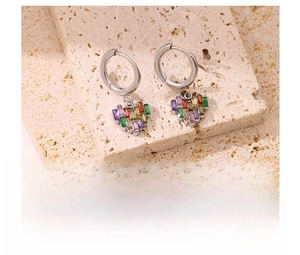 Gros plan de boucles d'oreilles cœur en zircon coloré sur fond en pierre