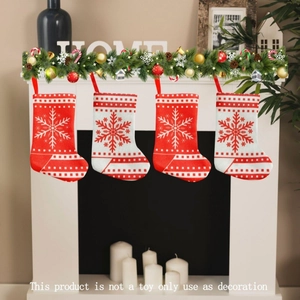 Set of four knitted Christmas stockings with snowflake patterns hung by a festive fireplace