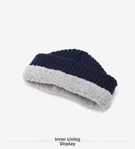 Detailed view of the navy knit beanie featuring a thick light grey fleece thermal lining