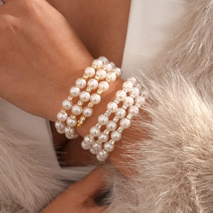 Luxurious multilayer pearl cuff bracelet with gold and silver diamond-encrusted spacers