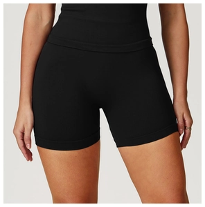 Detail of high-waisted black seamless yoga shorts with compression and body shaping fabric