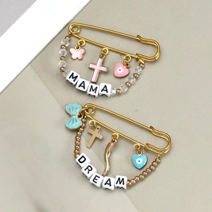 Detail of evil eye brooches featuring Mama and Dream beads with colorful butterfly charms