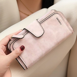 Detail of dusty rose matte long wallet with zipper and forever engraving held by hand