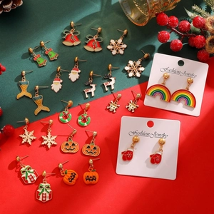 Detailed close-up of festive enamel Christmas earrings including Santa and Reindeer designs