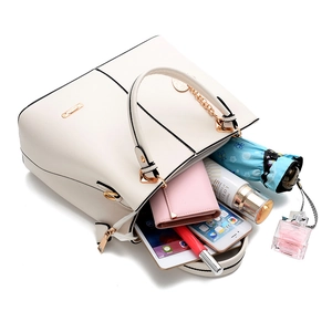 Detail view of spacious interior of cream tote bag with tablet and daily essentials