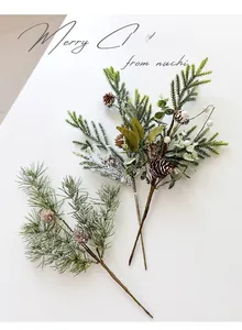 Detailed close-up of festive pine branches with pinecones and artificial white snow effects