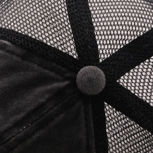 Detail of a washed cotton baseball cap showing top button and breathable mesh panels