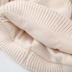 Beige kids knitted winter hat with soft warm lining and thick wool texture