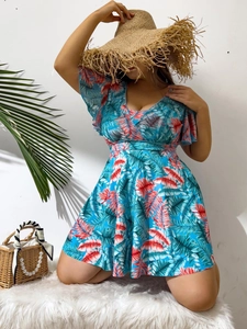 Detail of tropical palm leaf print on blue V-neck ruffled sleeve tankini swimsuit