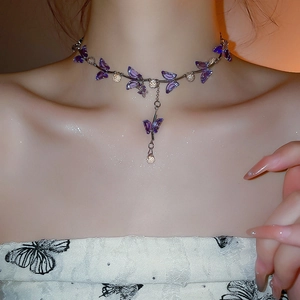 Close-up of purple crystal butterfly choker necklace on model with teardrop pendant
