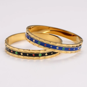 Enamel bangles with 18K gold plating and vintage floral patterns in blue and black