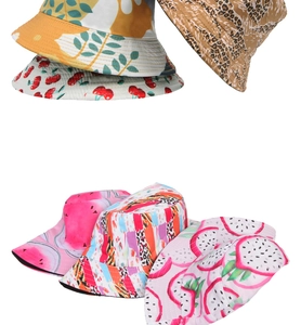 Stack of bucket hats featuring cherry, leopard, and floral prints in a detailed macro view
