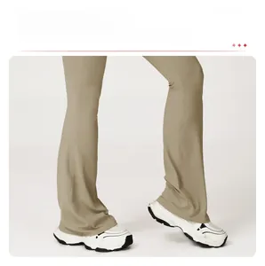 Detailed view of khaki flared yoga pants showing leg-lengthening silhouette and high-rise cut