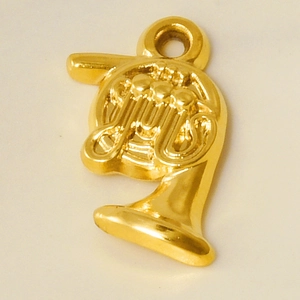 Macro view of a gold French horn pendant in 304 stainless steel for DIY necklace making