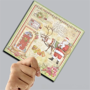 Close-up of vintage Christmas scrapbook paper with Santa and reindeer illustrations