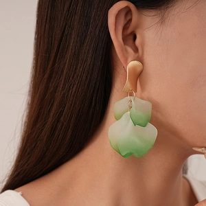 Detail of artistic gradient acrylic petal earrings with golden irregular metal top
