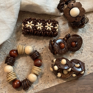 Bohemian elastic bracelets set made of natural coconut shell and wooden beads in brown tones