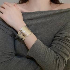 Detail of silver leaf cuff bracelet with hollow vein texture on model's wrist