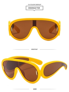 Front and side views of oversized Y2K shield sunglasses with yellow frames and brown lenses