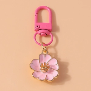 Close-up of pink cherry blossom keychain with gold trim and pink metal lobster clasp